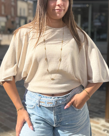 Pull cintré à la taille chauve souris beige